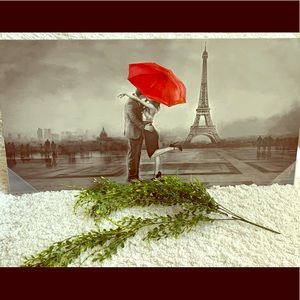 A painting that’s grey and a red umbrella